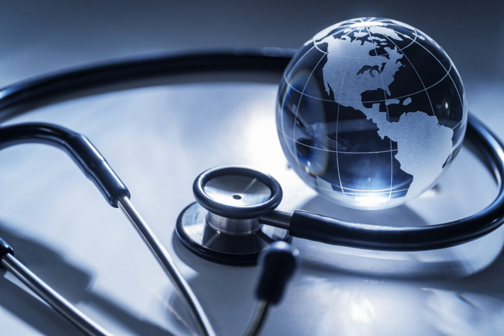 Stethoscope wrapped around a glass globe, representing population health