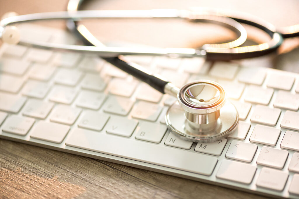 Stethoscope resting on a keyboard, representing evidence-based healthcare delivery